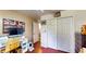 Bedroom featuring laminate wood flooring, closet space, and a workstation at 2333 Cheshire Pl, Lakeland, FL 33810