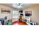 Bedroom featuring laminate wood flooring, closet space, and a workstation at 2333 Cheshire Pl, Lakeland, FL 33810