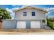 Two-story home featuring a two-car garage and neutral siding, with stairs leading to the front porch at 2333 Cheshire Pl, Lakeland, FL 33810