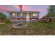 Charming two-story home featuring eye-catching architecture, a lovely fountain, and a well-maintained lawn at twilight at 2333 Cheshire Pl, Lakeland, FL 33810