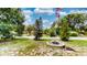 Charming front yard with a fountain, landscaping, and a view of the street at 2333 Cheshire Pl, Lakeland, FL 33810