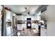 Well-lit kitchen featuring white cabinets, a stainless steel refrigerator, and modern appliances at 2333 Cheshire Pl, Lakeland, FL 33810
