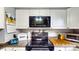 Close-up of kitchen features, including the oven, microwave, and countertop space at 2333 Cheshire Pl, Lakeland, FL 33810