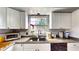 Practical kitchen area with a sink overlooking the backyard and essential appliances at 2333 Cheshire Pl, Lakeland, FL 33810