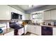 Functional kitchen design boasts white cabinets, modern appliances, durable countertops, and a window for natural light at 2333 Cheshire Pl, Lakeland, FL 33810
