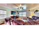 Comfortable living room with a large sectional sofa, hardwood floors, and a modern entertainment center at 2333 Cheshire Pl, Lakeland, FL 33810