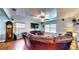 Bright and airy living room with a large sofa, hardwood floors, a ceiling fan, and plenty of natural light at 2333 Cheshire Pl, Lakeland, FL 33810