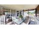 Covered patio area with a glass-topped table, chairs, and potted plants for outdoor relaxation at 2333 Cheshire Pl, Lakeland, FL 33810