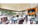 Relaxing screened patio featuring a dining table set, views, and a TV for outdoor entertainment at 2333 Cheshire Pl, Lakeland, FL 33810