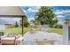 Relaxing covered patio with outdoor seating and a view of the spacious, well-maintained backyard at 2333 Cheshire Pl, Lakeland, FL 33810