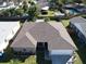 Aerial view of home and landscaped backyard with mature trees and lawns at 244 Kings Pond Ave, Winter Haven, FL 33880