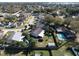 Aerial view of the neighborhood, home, pool, and fenced yard at 244 Kings Pond Ave, Winter Haven, FL 33880