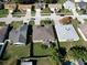 Aerial view showcasing a home's backyard, fencing, patio, and landscaping in a suburban neighborhood at 244 Kings Pond Ave, Winter Haven, FL 33880