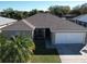 This aerial view showcases the house's layout, roof, and curb appeal from an elevated perspective at 244 Kings Pond Ave, Winter Haven, FL 33880