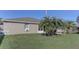 Expansive backyard featuring lush green grass and mature palm trees providing ample shade at 244 Kings Pond Ave, Winter Haven, FL 33880