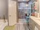 Beautiful bathroom with a glass-enclosed shower and gray-tiled accent wall at 244 Kings Pond Ave, Winter Haven, FL 33880
