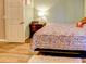 Bedroom features wood floors, bright natural lighting, and a teddy bear accent at 244 Kings Pond Ave, Winter Haven, FL 33880