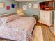 Comfortable bedroom with a floral quilt, wood floors, and accenting decor at 244 Kings Pond Ave, Winter Haven, FL 33880