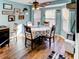 Bright dining area features wood floors, ceiling fan, and a floral tablecloth at 244 Kings Pond Ave, Winter Haven, FL 33880