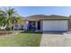 Charming home featuring a well-manicured lawn and a welcoming front porch area with mature landscaping at 244 Kings Pond Ave, Winter Haven, FL 33880