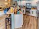 Spacious kitchen featuring an island with seating, stainless steel appliances, and access to the living room at 244 Kings Pond Ave, Winter Haven, FL 33880