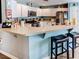 Inviting kitchen with white cabinetry, a breakfast bar, and plenty of countertop space for meal preparation at 244 Kings Pond Ave, Winter Haven, FL 33880