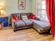 Comfortable living room with sectional sofa, throw pillows, and wood floors at 244 Kings Pond Ave, Winter Haven, FL 33880