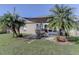 Enjoy outdoor living on this cozy patio, shaded by palm trees, perfect for entertaining or relaxing at 244 Kings Pond Ave, Winter Haven, FL 33880