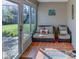Cozy sunroom with tiled floor and comfortable seating overlooking the backyard at 244 Kings Pond Ave, Winter Haven, FL 33880