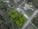 Aerial view showcasing the property boundary, driveway, and mature trees at 257 Padgett N Pl, Lakeland, FL 33809