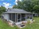 View of backyard with screened patio and a storage shed at 257 Padgett N Pl, Lakeland, FL 33809