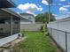 View of the fenced backyard, patio and the exterior of the home at 257 Padgett N Pl, Lakeland, FL 33809