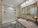 Bathroom with tub, tiled walls, and decorative wallpaper at 257 Padgett N Pl, Lakeland, FL 33809