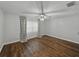 Bedroom with ceiling fan, neutral walls, and stylish wood-look flooring at 257 Padgett N Pl, Lakeland, FL 33809