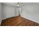 Bedroom featuring hardwood floors, closet, and ceiling fan at 257 Padgett N Pl, Lakeland, FL 33809