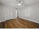 Bedroom featuring hardwood floors, closet, and ceiling fan at 257 Padgett N Pl, Lakeland, FL 33809