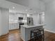 Modern kitchen featuring white cabinets, stainless steel appliances, and a large island with seating at 257 Padgett N Pl, Lakeland, FL 33809