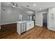 Bright open-concept kitchen with an island and stainless steel appliances, seamlessly flowing into the living area at 257 Padgett N Pl, Lakeland, FL 33809