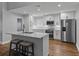 Modern kitchen featuring white cabinets, stainless steel appliances, and a large island with seating at 257 Padgett N Pl, Lakeland, FL 33809