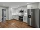 Modern kitchen with stainless steel appliances, white cabinets, white countertop and brick backsplash at 257 Padgett N Pl, Lakeland, FL 33809