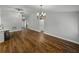 Open-concept living room features wood floors and decorative chandelier at 257 Padgett N Pl, Lakeland, FL 33809