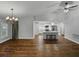 Open-concept living space with hardwood floors, modern lighting, and kitchen with island at 257 Padgett N Pl, Lakeland, FL 33809