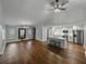 Open-concept living space with kitchen, stainless appliances, island, and hardwood floors at 257 Padgett N Pl, Lakeland, FL 33809