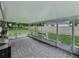 Covered patio with stone floors and views of the backyard at 257 Padgett N Pl, Lakeland, FL 33809