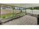 Enclosed patio boasts pavers and a view of the fenced in backyard at 257 Padgett N Pl, Lakeland, FL 33809