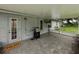 Covered patio with stone floors, grill, and ceiling fan at 257 Padgett N Pl, Lakeland, FL 33809