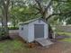 Shed shows ramp and door with greenery around the perimeter at 257 Padgett N Pl, Lakeland, FL 33809
