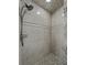 Shower stall tiled with gray stone and mosaic accents at 257 Padgett N Pl, Lakeland, FL 33809