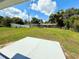 Expansive back yard view with a concrete pad and neighboring houses behind a chain-link fence at 2655 Hempstead Dr, Lakeland, FL 33801