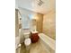 This bathroom has a brown tiled wall and a vanity at 2655 Hempstead Dr, Lakeland, FL 33801